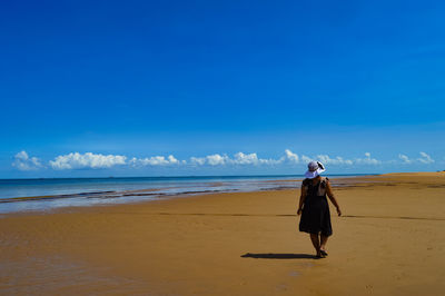 Full length of man on beach against sky