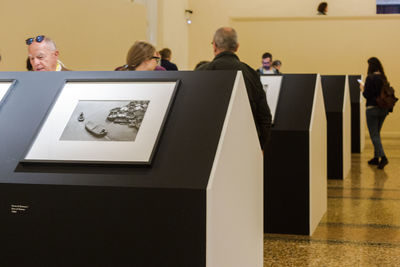 Rear view of people photographing in museum