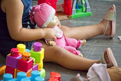 Midsection of women playing with toy
