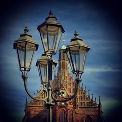 Low angle view of illuminated street light against sky