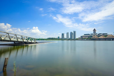 Bridge over river with city in background