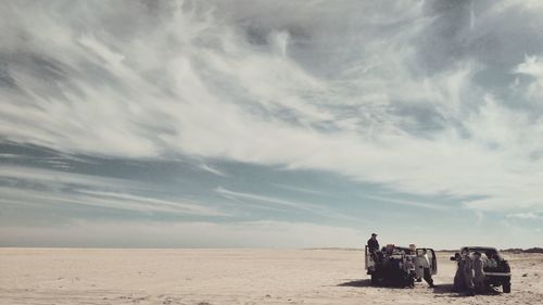 People on beach against sky