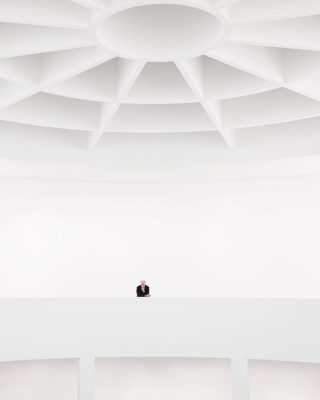 indoors, architecture, white color, ceiling, built structure, one person, lifestyles, pattern, real people, day, men, home interior, white, copy space, modern, wall - building feature, steps and staircases, building, staircase