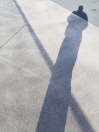 Shadow of person on road