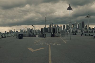 Empty road with buildings in background