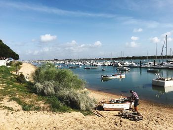 Boats moored on sea against sky