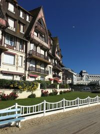 Buildings in town against clear blue sky