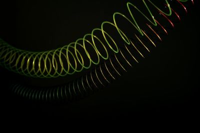 Close-up of spiral lights over black background