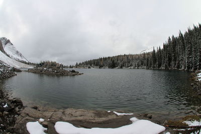 Scenic view of frozen lake against cloudy sky