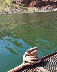 High angle view of rope tied to moored at harbor