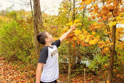 Full length of boy standing on field during autumn