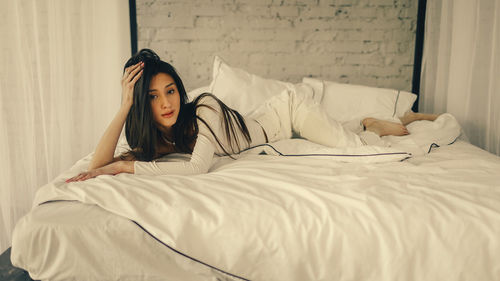 Young woman sleeping on bed at home