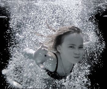 Portrait of young woman in water