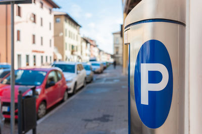 Close-up of road sign against sky