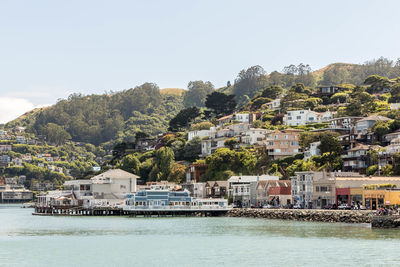 View of townscape by sea against sky