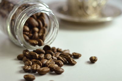 Close-up of coffee beans in glass jar on table
