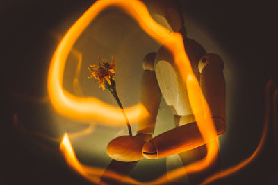 Close-up of light painting against figurine