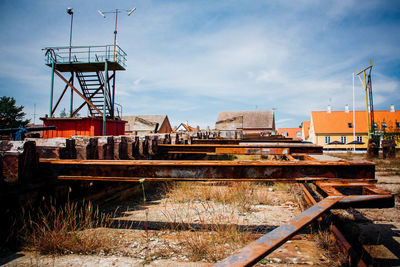 Rusty metal at ship yard against sky