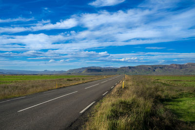 Empty road along countryside landscape