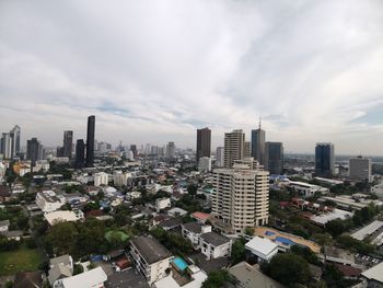 Aerial view of buildings in city against sky