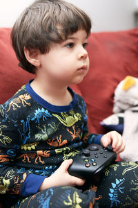 Close-up of boy using mobile phone