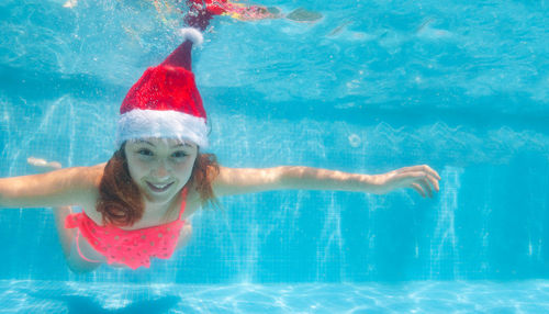 Portrait of woman swimming in pool