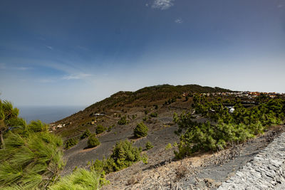 Scenic view of sea and mountains against sky