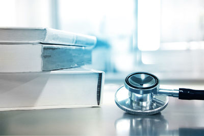 Close-up of stethoscope and books on table