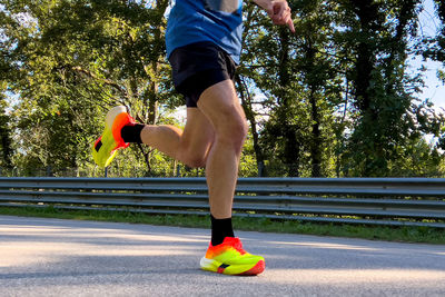 Low section of man skateboarding on footpath