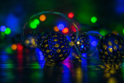 Close-up of illuminated glass ball on table