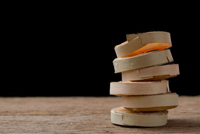 Close-up of stack on table against black background