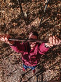 High angle view portrait of smiling man on tree