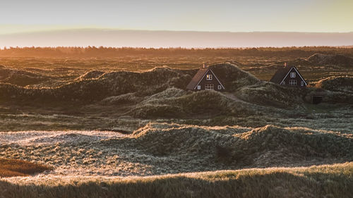 Aerial view of land against sky during sunset