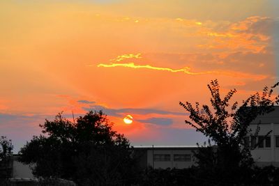 Scenic view of house at sunset