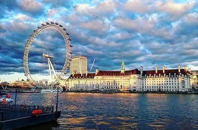 Ferris wheel against cloudy sky