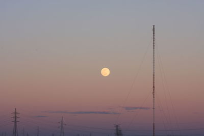 Low angle view of silhouette moon against sky at sunset