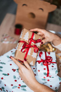 Midsection of woman holding paper in box