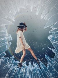 Digital composite image of woman standing in glass