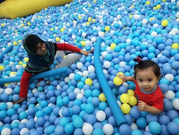 High angle view of sisters in ball pool