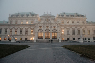 Facade of historic building against sky at dusk