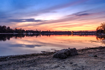 Scenic view of lake against sky during sunset