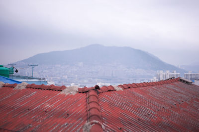 High section of rooftop against mountain range