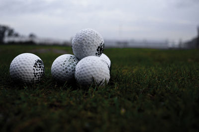 Close-up of golf balls on field