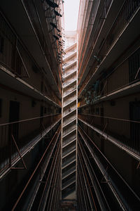 Low angle view of railroad tracks amidst buildings in city