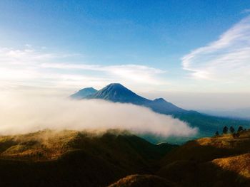 Scenic view of mountains against cloudy sky