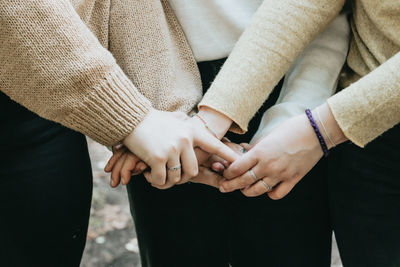 Midsection of couple holding hands