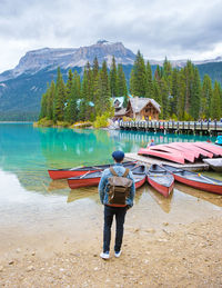 Rear view of man standing in boat