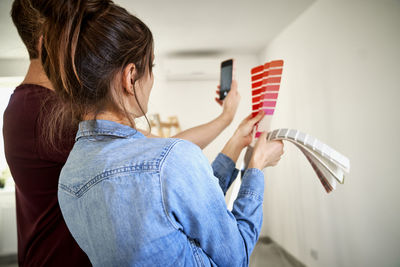 Side view of young woman using mobile phone