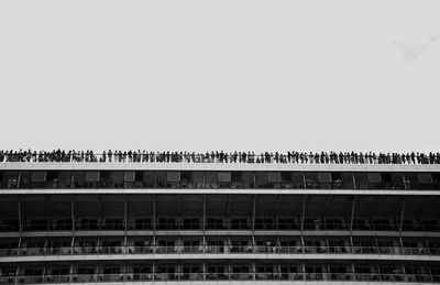 People standing on building terrace against sky