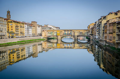 Ponte vecchio over arno river against clear sky